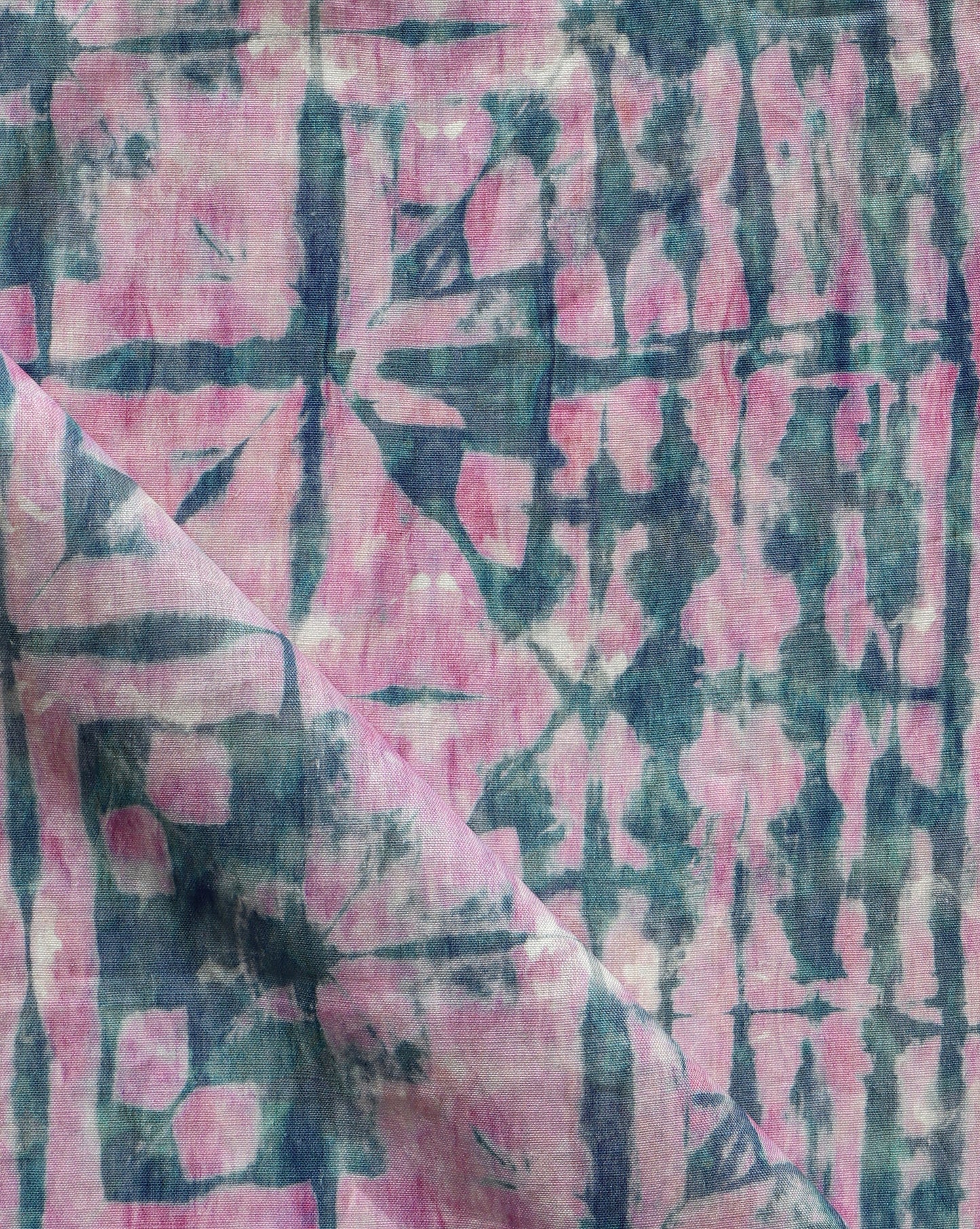 A high-end Banda Fabric with a pink and blue tie dyed pattern created using shibori tie-dye techniques