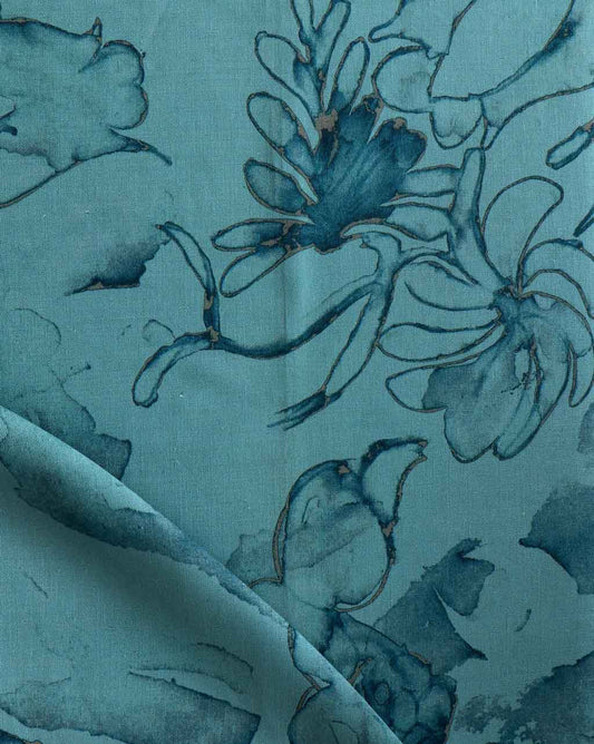 A close up of a teal fabric with Belize Blooms Fabric Aquamarine flowers on it