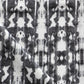 A close up of Biami Fabric Black, a high-end black and white tie dye fabric