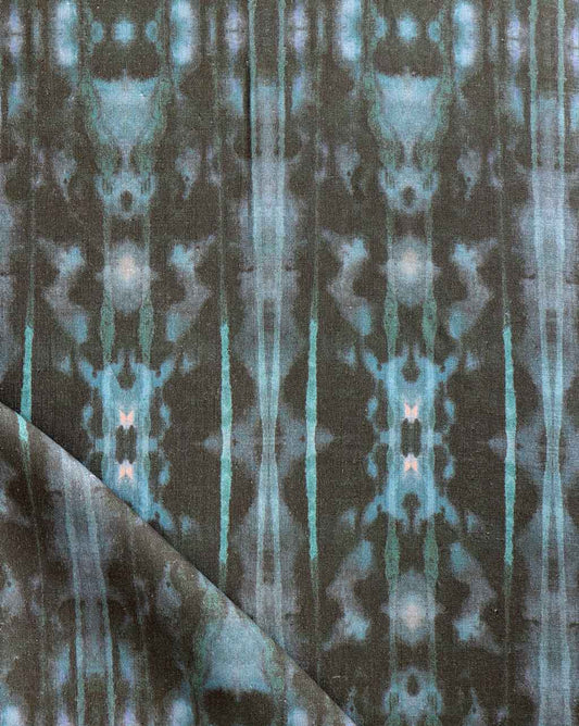 A close up of a blue and green tie-dyed high-end Biami Fabric in the Waterstone pattern