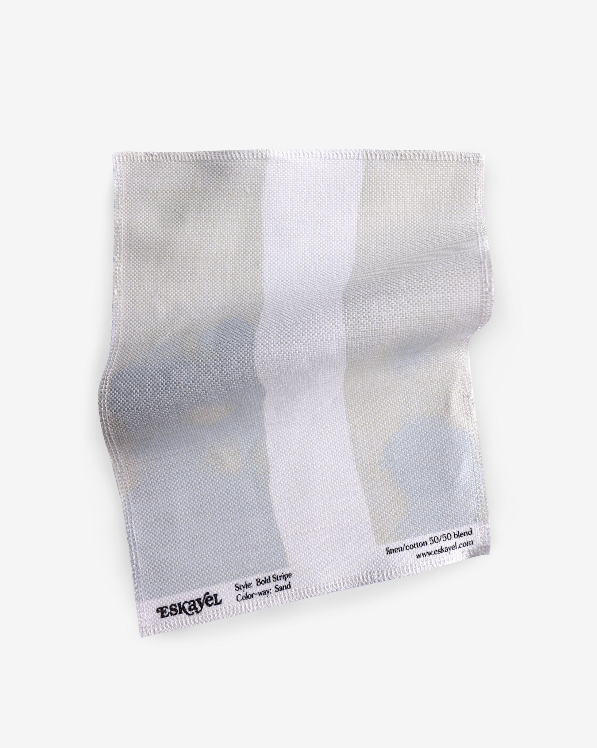 A white cloth with a white Bold Stripe Fabric||Sand on it.