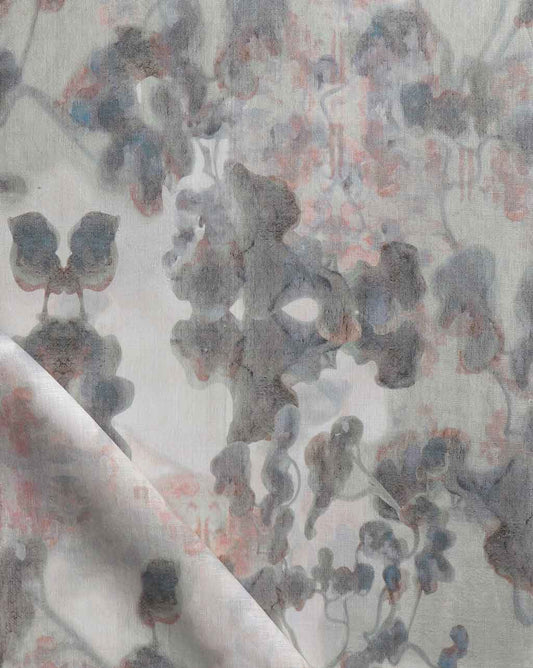A close up of a high-end custom wallpaper featuring a grey and blue floral print from the Clemente Fabric Sol Collection, showcasing luxury fabric
