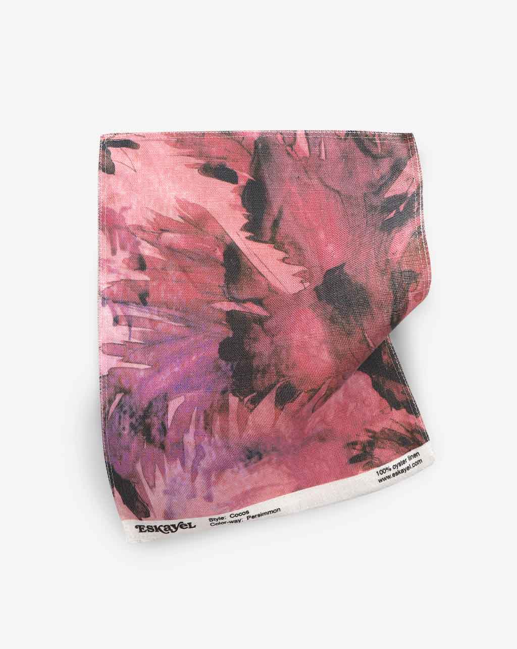 A luxury pink and black Cocos Fabric Persimmon painting on a piece of fabric featuring palm tree motifs
