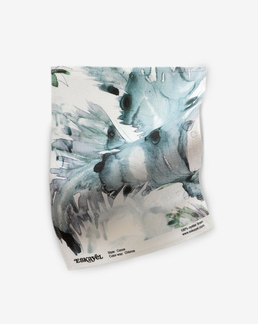 Hand-painted Cocos Chloros Fabric sample in watery blue, green, grey, and black on a white background | Eskayel