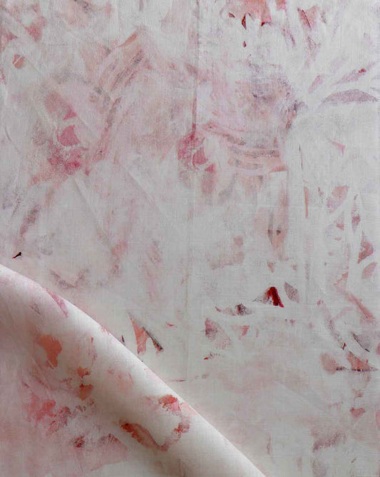 A close up of pink and white Cortile Fabric Pelle paint on a piece of fabric, perfect for custom pillows or rugs