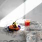 A plate of fruit on a table with a luxurious fabric from the Salentu Collection and the Domenica Fabric Notte