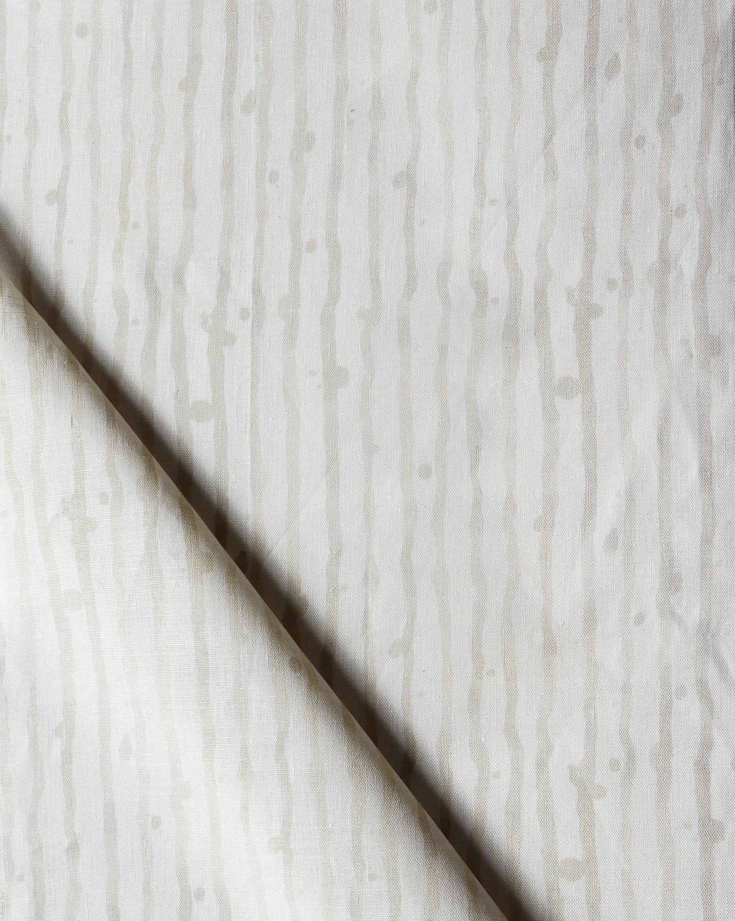 A close up of a white and gray Drippy Stripe Fabric Sand