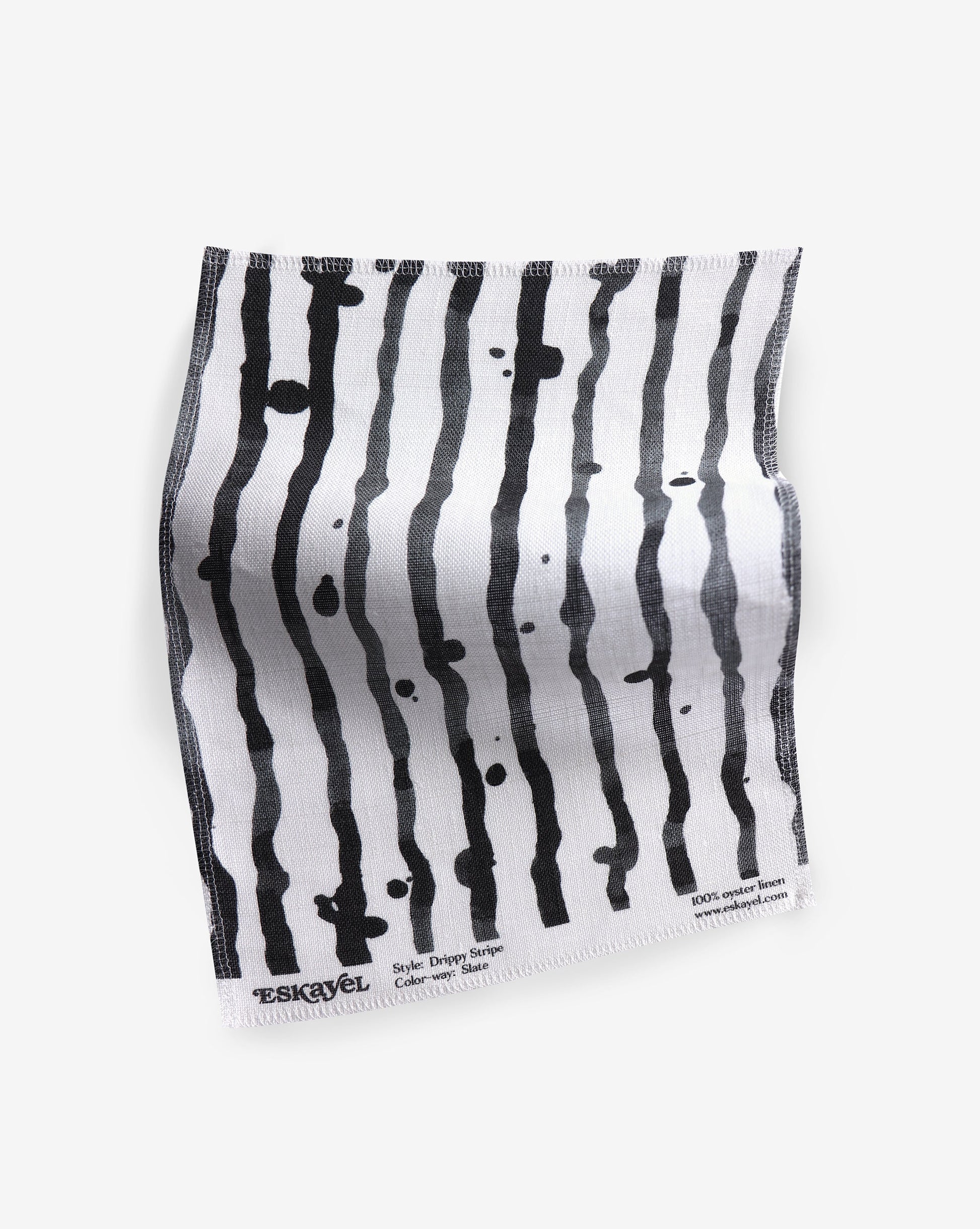 A Drippy Stripe Fabric||Slate piece with black and white stripes in Eskayel's signature inky style.