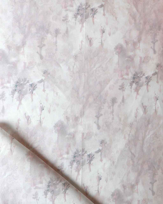 A pink and white Emvasia Fabric Alba with trees on it
