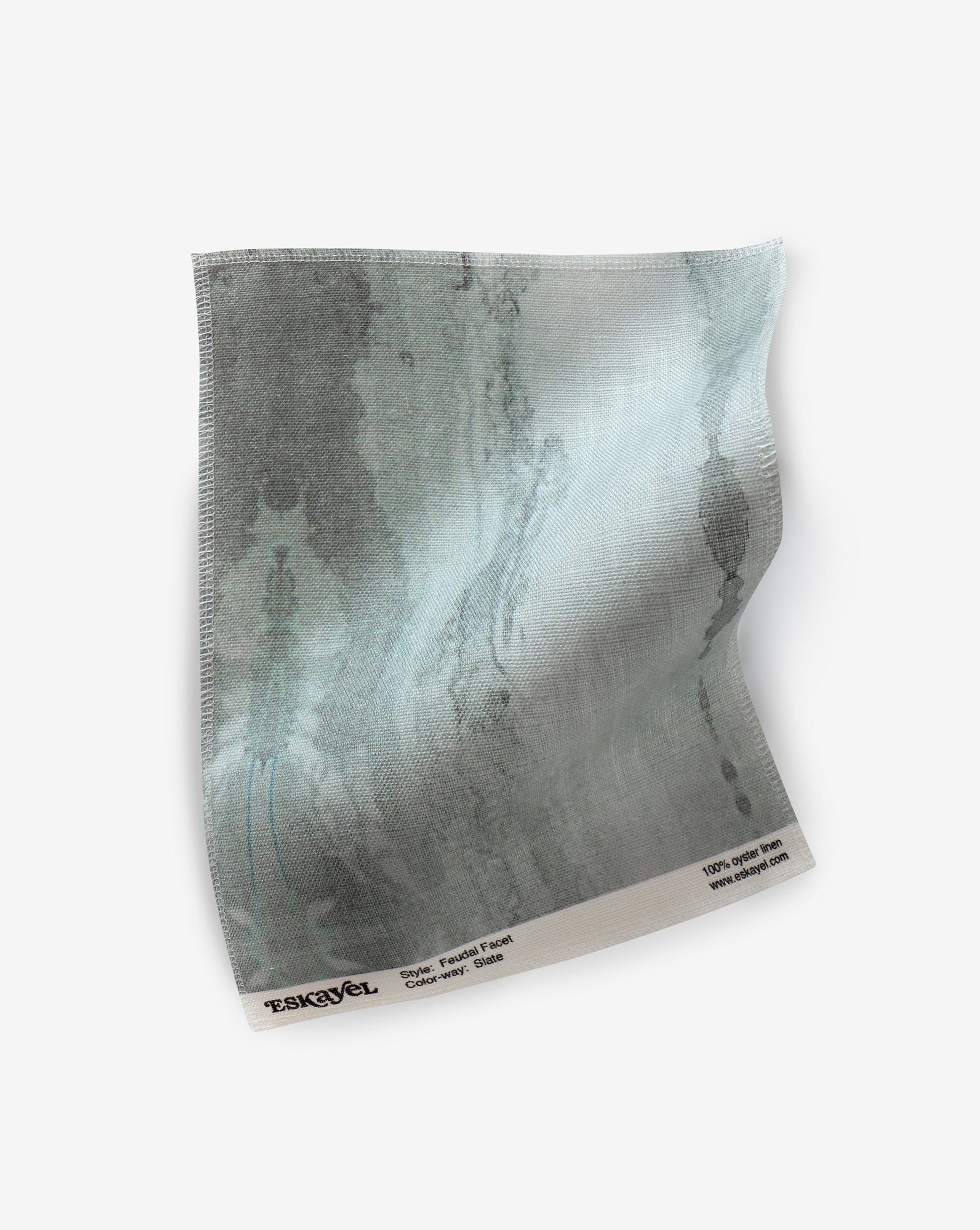 A blue and gray design on a piece of Feudal Facet Fabric Slate from the Era Collection