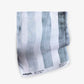 A blue and white striped Gradient Stripe Fabric Slate on a white surface
