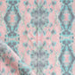 A pink and blue fabric with a Hive Fabric Citron pattern on it