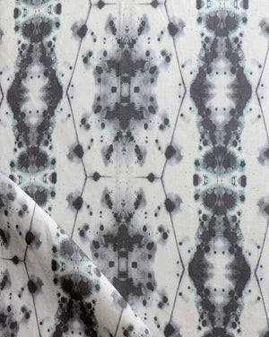 A close up of a black and white Hive Fabric in the Waterstone colorway
