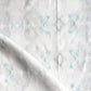 A close up of Icelandic Mist Fabric with blue and white designs.