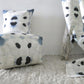 A blue and white Galileo Glass Fabric Shale pillow with an abstract polka dot pattern