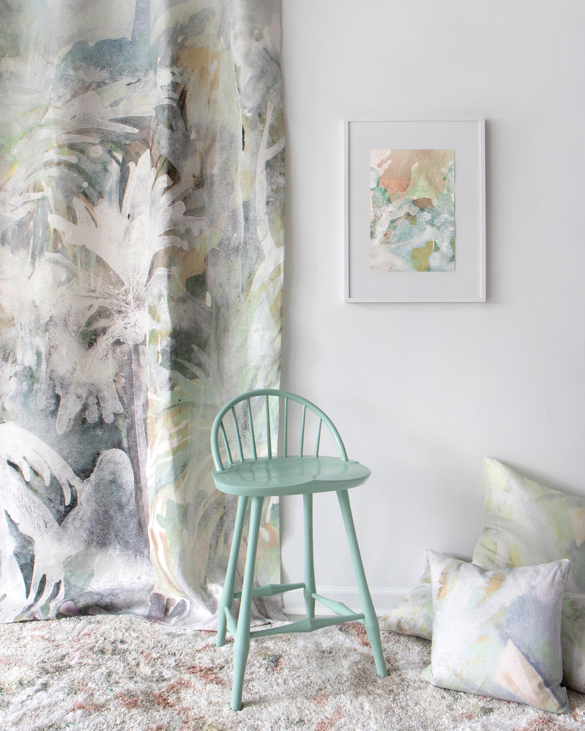 A Regalo di Dio Fabric Verde chair in front of a wall with coastal living wallpaper