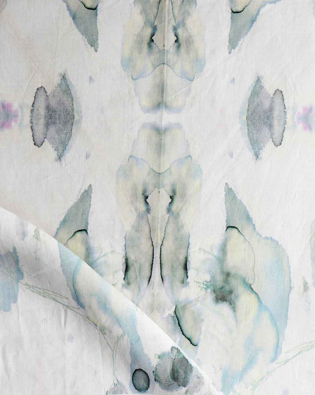 A white Madagascar Fabric Mist sheet with blue and white flowers on it