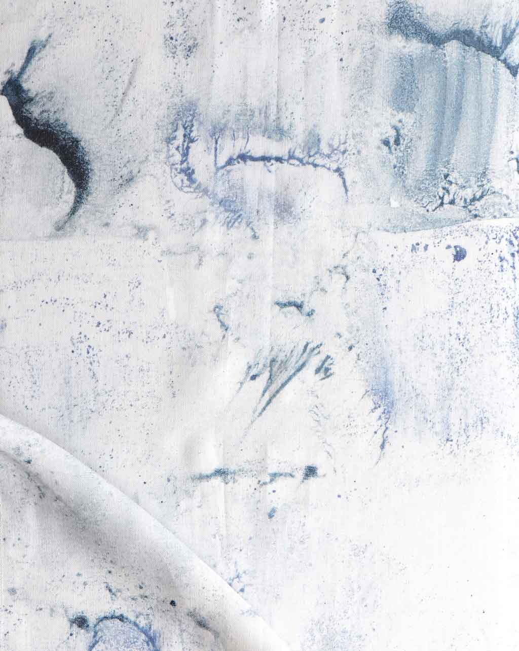 A close up of a blue and white painting on a piece of Melting Checks Fabric Ocean with muted blues