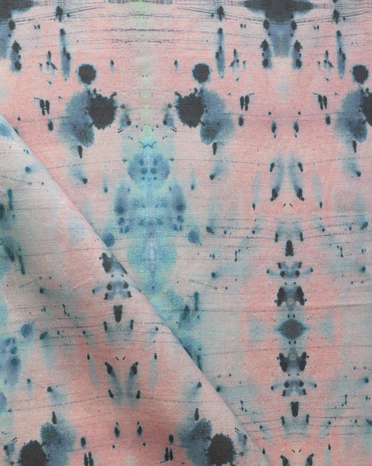 A close up of a pink and blue tie dyed Nairutya Fabric Citron from the Jangala Collection