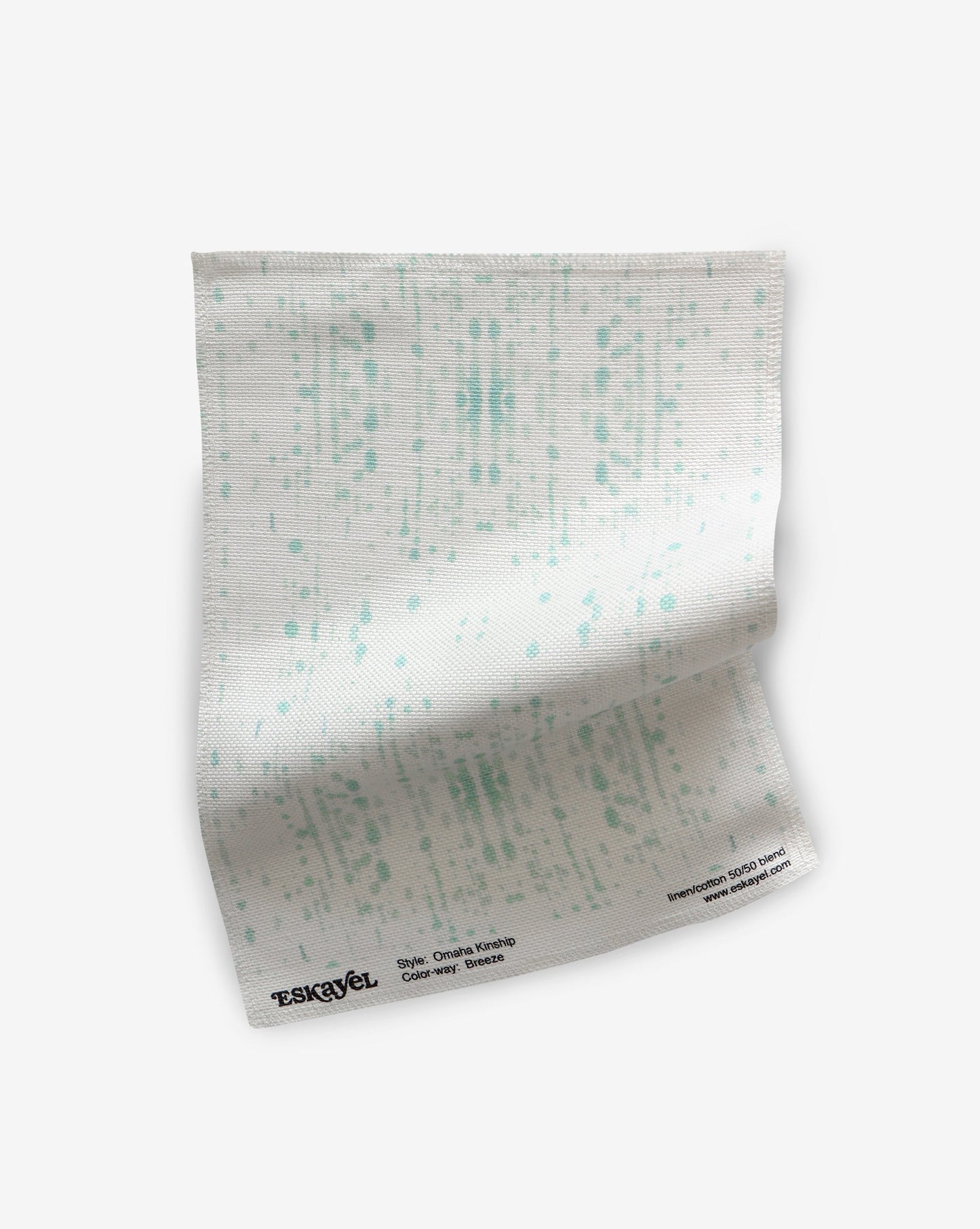 A white Omaha Kinship Fabric Sample Breeze with dots on it, suitable for order