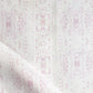 A pink and white Omaha Kinship Fabric with dots on it, in Eskayel's high-end Omaha Kinship pattern
