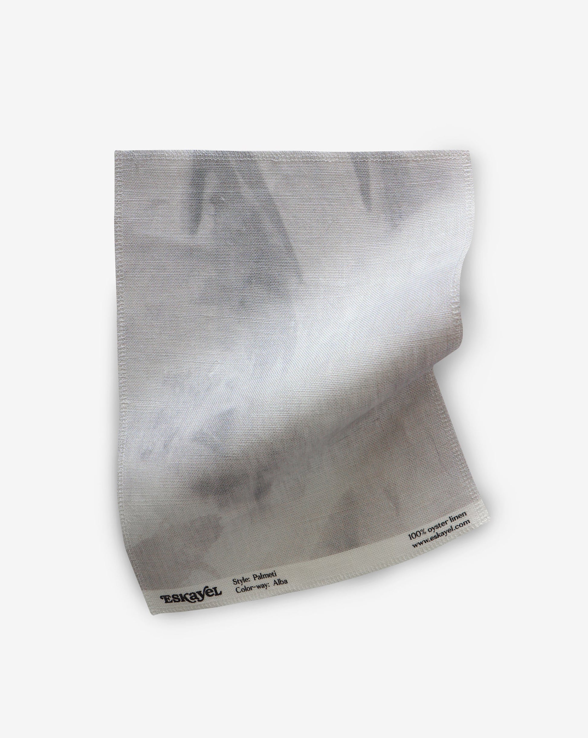 A white piece of Palmeti Fabric Alba on a white surface