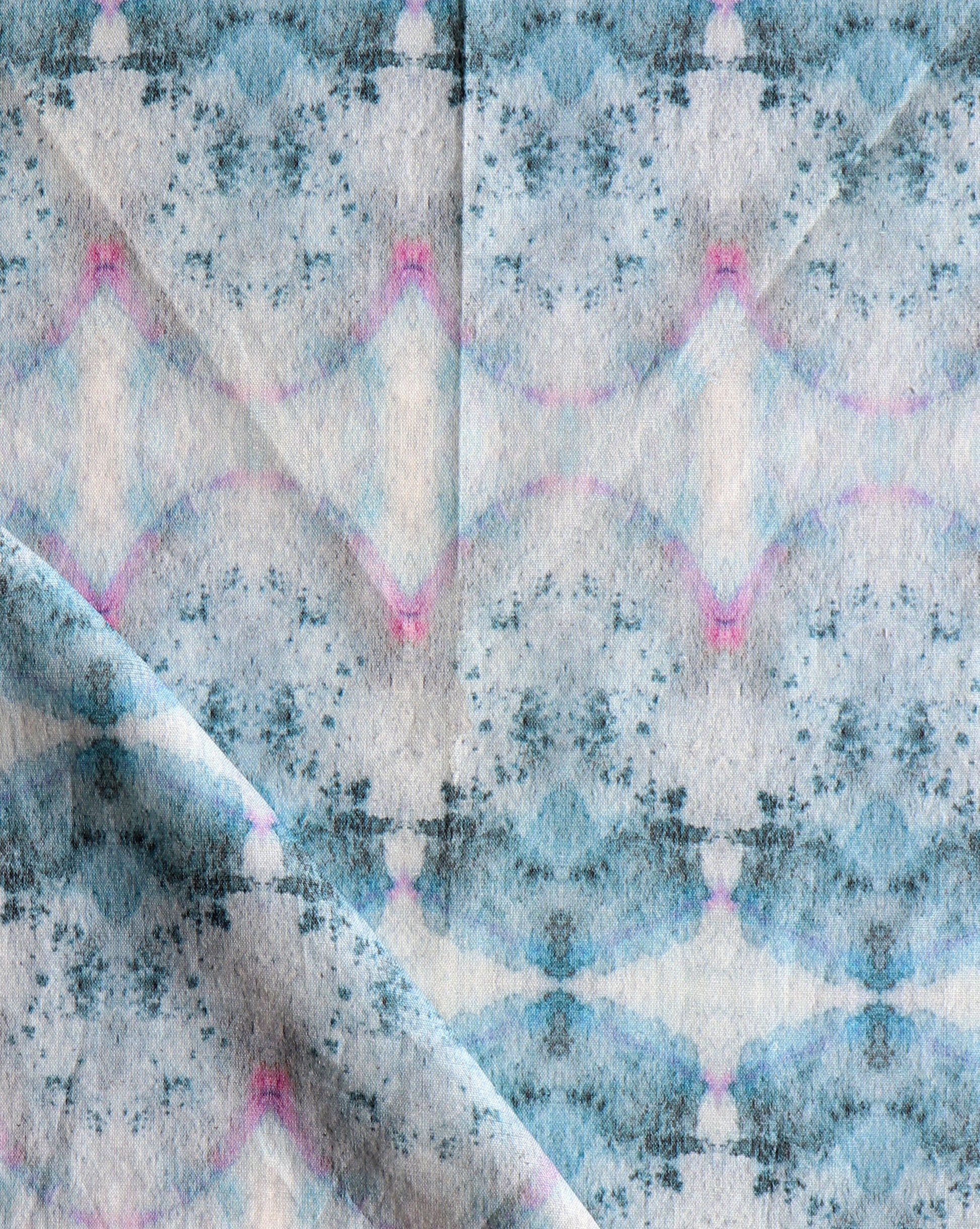 A blue and pink Parvati Fabric Cerulean from Eskayel's Dea Collection with a watercolor pigments pattern on it