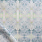 A close up of a white Parvati Fabric Nyanza with a Parvati pattern, featuring blue and green colors created using watercolor pigments