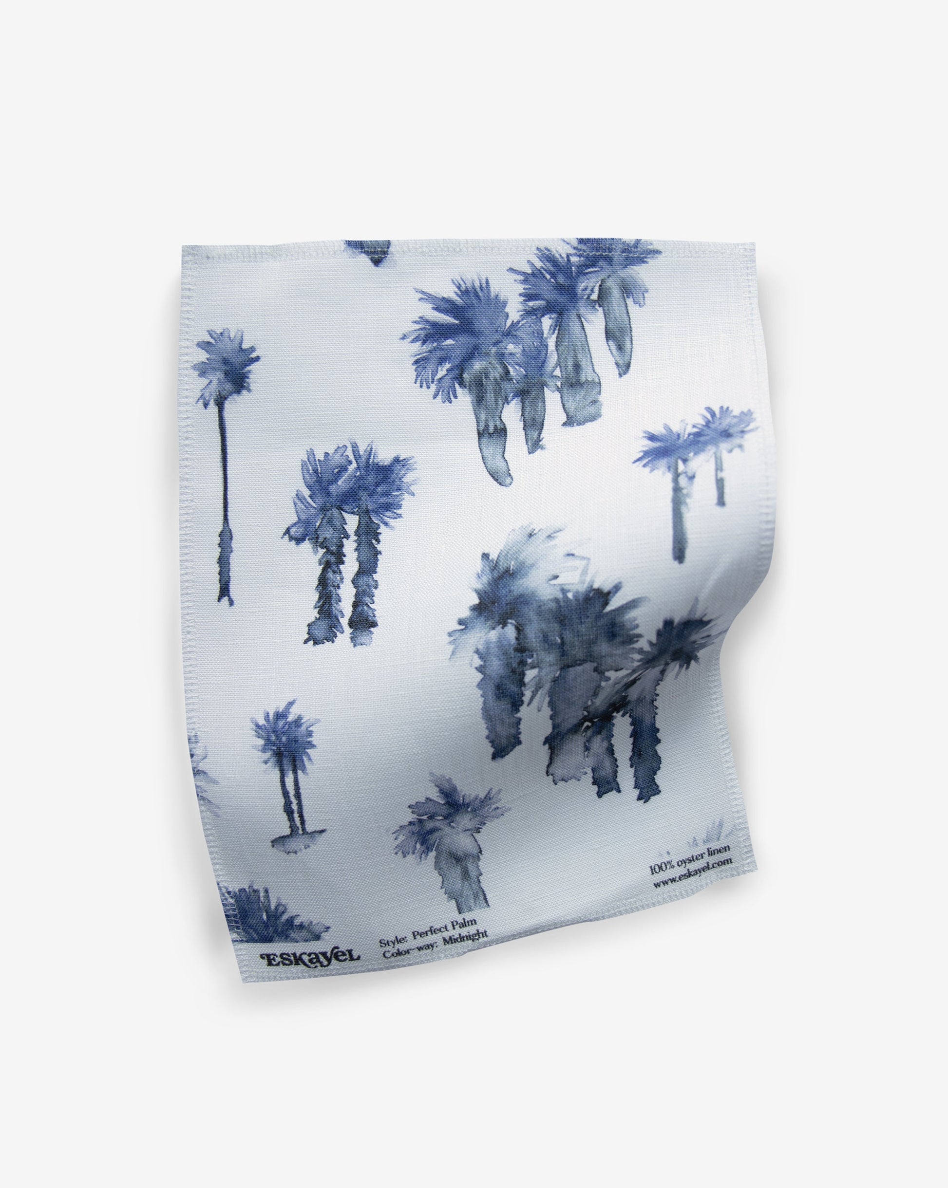 A blue and white Perfect Palm Fabric Midnight fabric with palm trees in a watercolor style