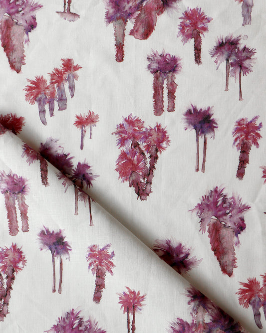 A pink and purple Perfect Palm Fabric Persimmon with palm trees on it made from luxury fabric