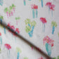 A close up of Perfect Palm Fabric Polychrome with watercolor style cactus trees on it