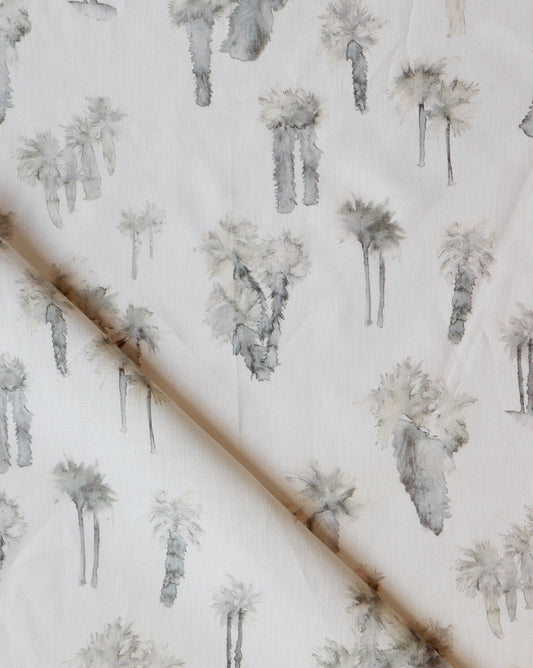 A white Perfect Palm Fabric Sand with a surfing pattern and palm trees on it