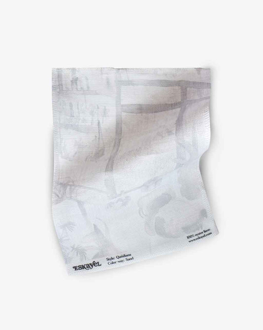 A white napkin with a Quotidiana Fabric Sample Sand on it can be ordered