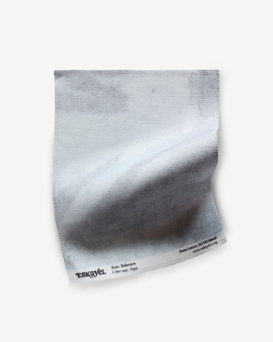 An Reflettere Fabric Sample Aqua on a white surface