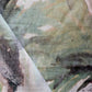 A close up of a Regalo di Dio Fabric Verde with a Regalo Di Dio painting on it