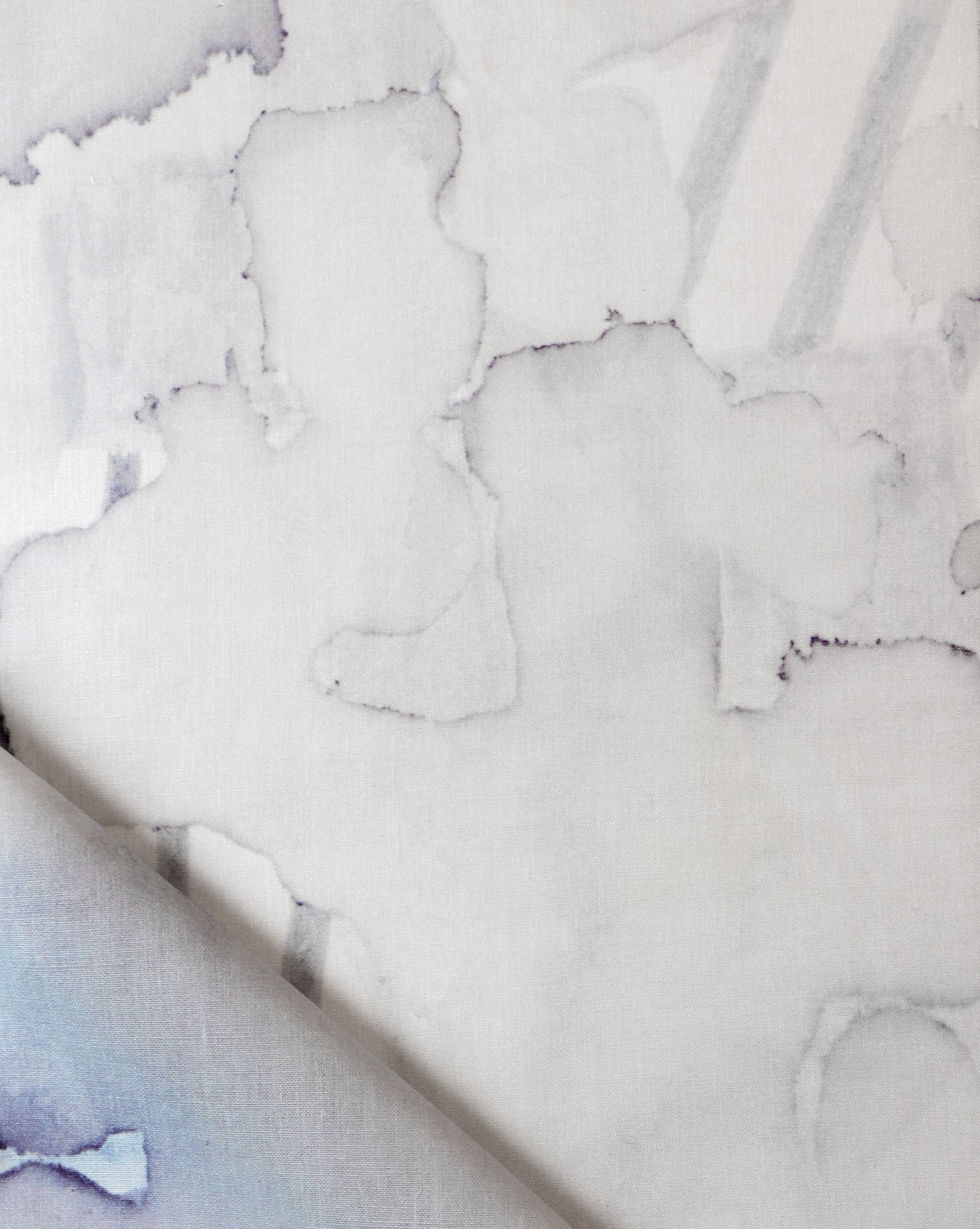 A close up of Sea Galaxy Fabric Ice artwork with blue and white paint on it