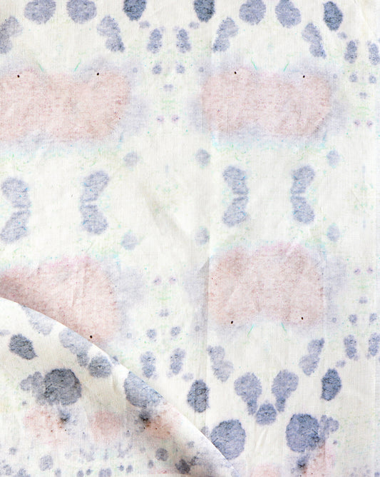 A close up of Species Fabric with a kaleidoscopic effect and pink and blue pattern