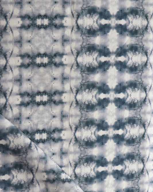 A close up of a blue and white tie dyed fabric from the Tauri Fabric Indigo Collection