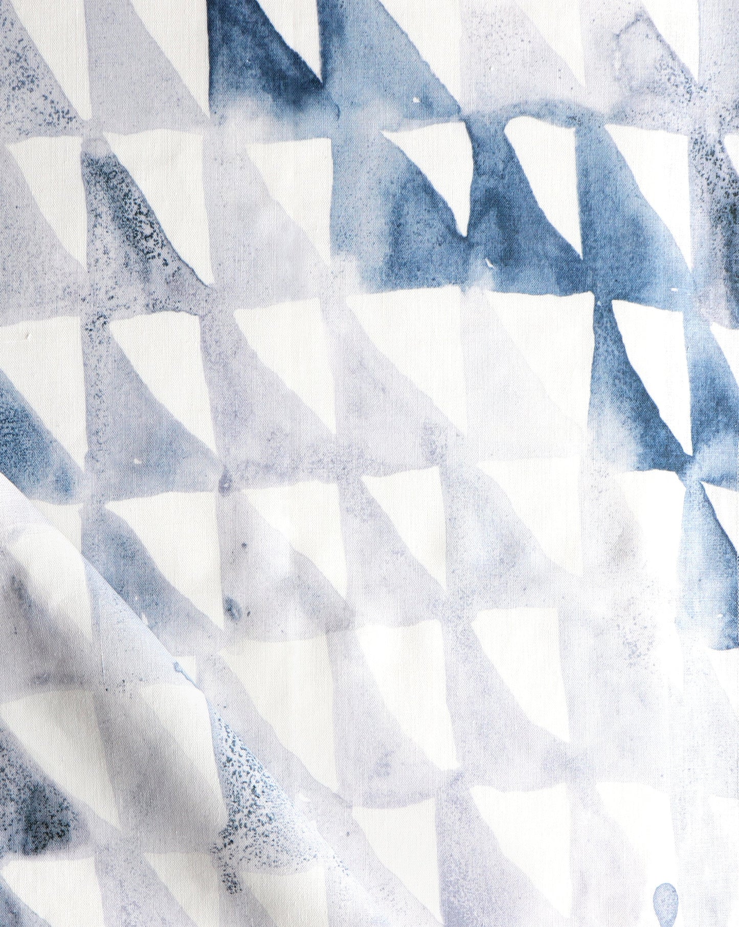 A close up of a blue and white Triangle Checks Fabric Ocean with triangles on it in the Triangle Checks collection