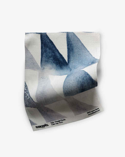 A Triangle Checks Fabric Sample Ocean with a blue and white design on it