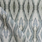 A close up of Ula Fabric Cerulean, a high-end fabric with a blue and white pattern