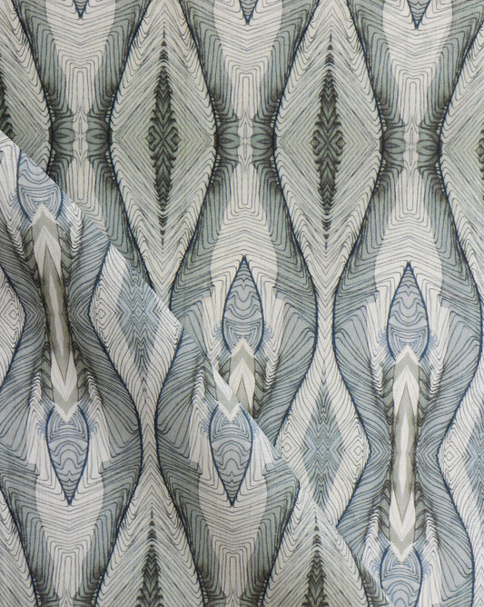A close up of Ula Fabric Cerulean, a high-end fabric with a blue and white pattern
