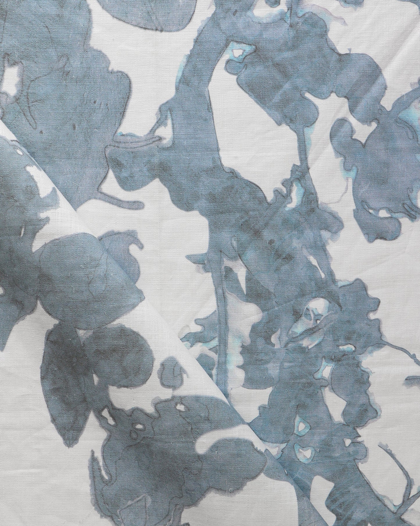 A close up of a blue and white print on an Up For Anything Fabric Cerulean, abstract botanical pattern