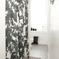 A black and white bathroom with a Up For Anything Fabric watercolor shower curtain