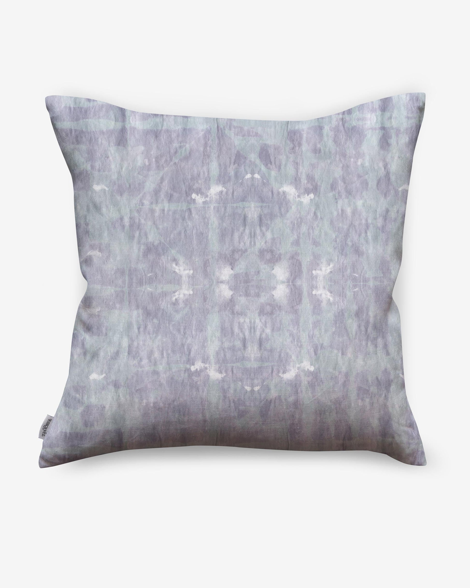 A pillow with a blue and white Banda Pillow||Cay pattern on it.