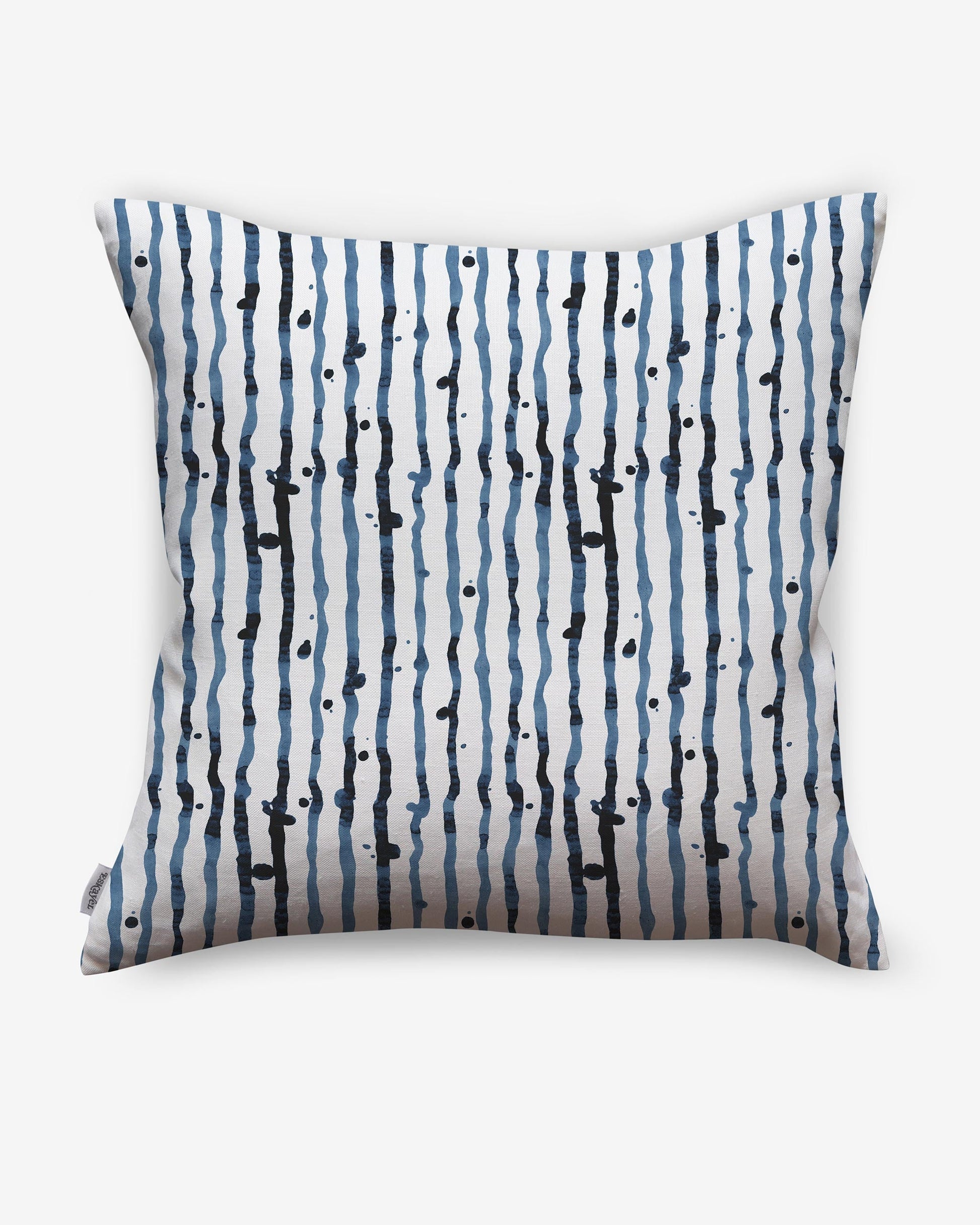 A pillow with a blue and black Drippy Stripe Pillow Azure pattern on it