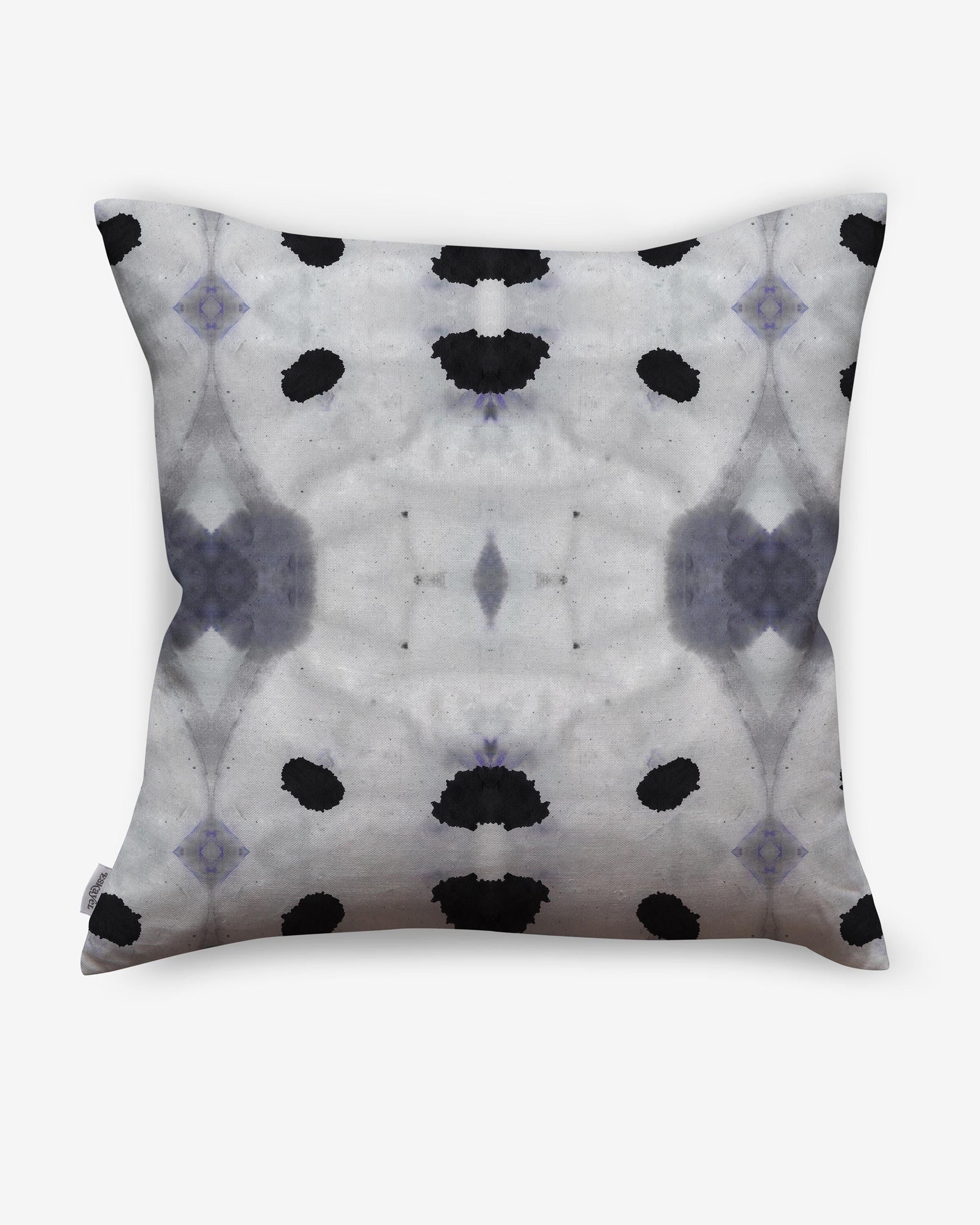 A Galileo Glass Pillow Indigo with abstract patterns of black and white dots on it