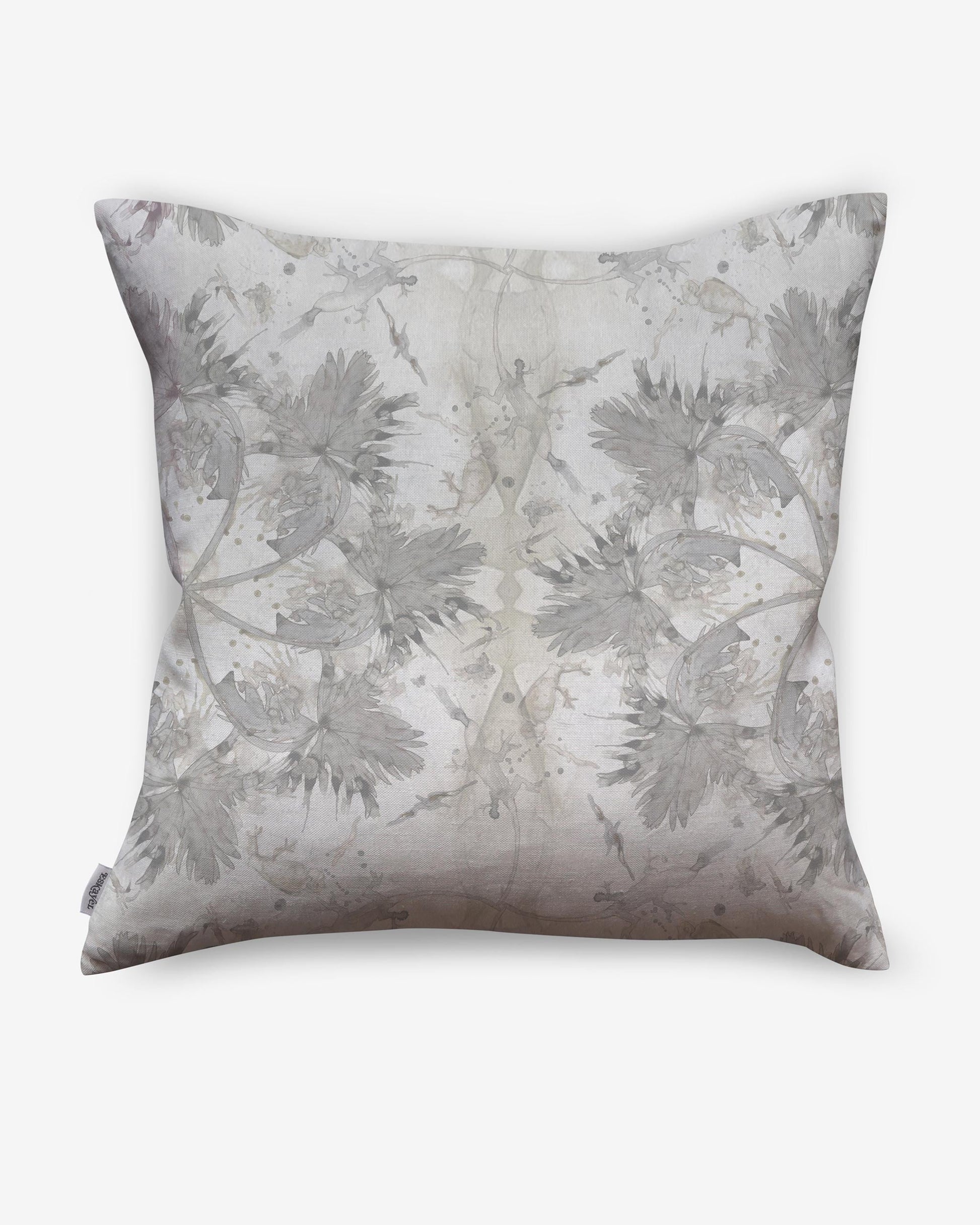 A Laurel Forest Pillow with a luxury fabric and a white and gray design on it, creating a Laurel Forest-inspired tropical atmosphere