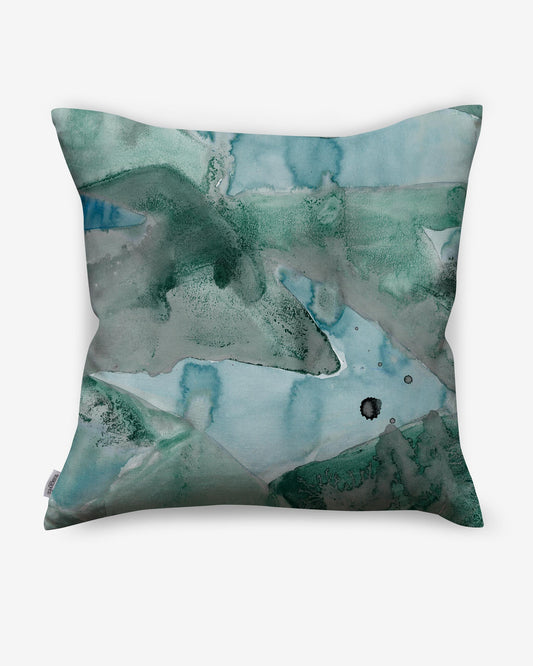A luxurious Mani Pillow with a vibrant Mani-inspired watercolor painting in green and blue colorways.