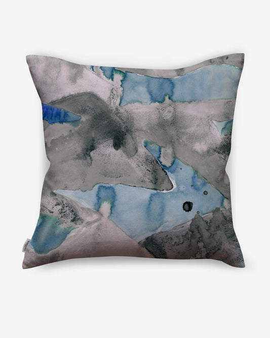 A Mani Pillow with an abstract painting on it.